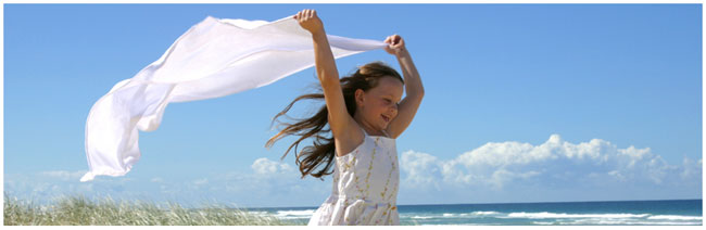 FrontPage Hosting - Small girl running free on the beach.